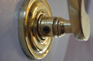 Remove the screw in the door knob first