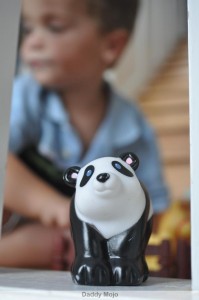 A Toddler plays with a Panda watermark