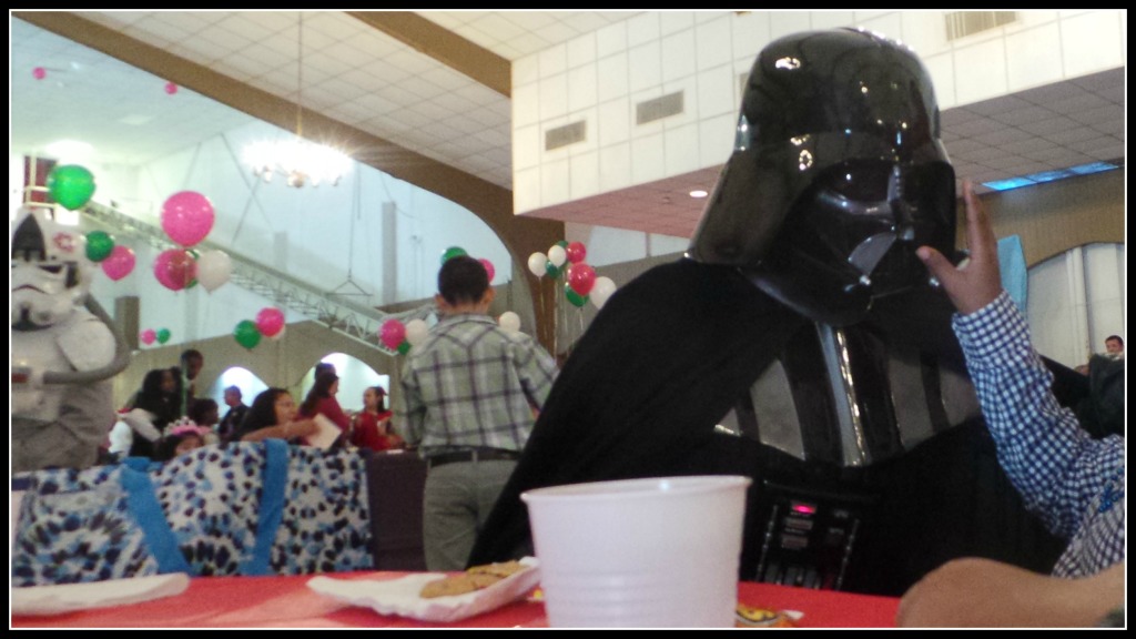 Darth Vader, with a blind patient feeling his mask